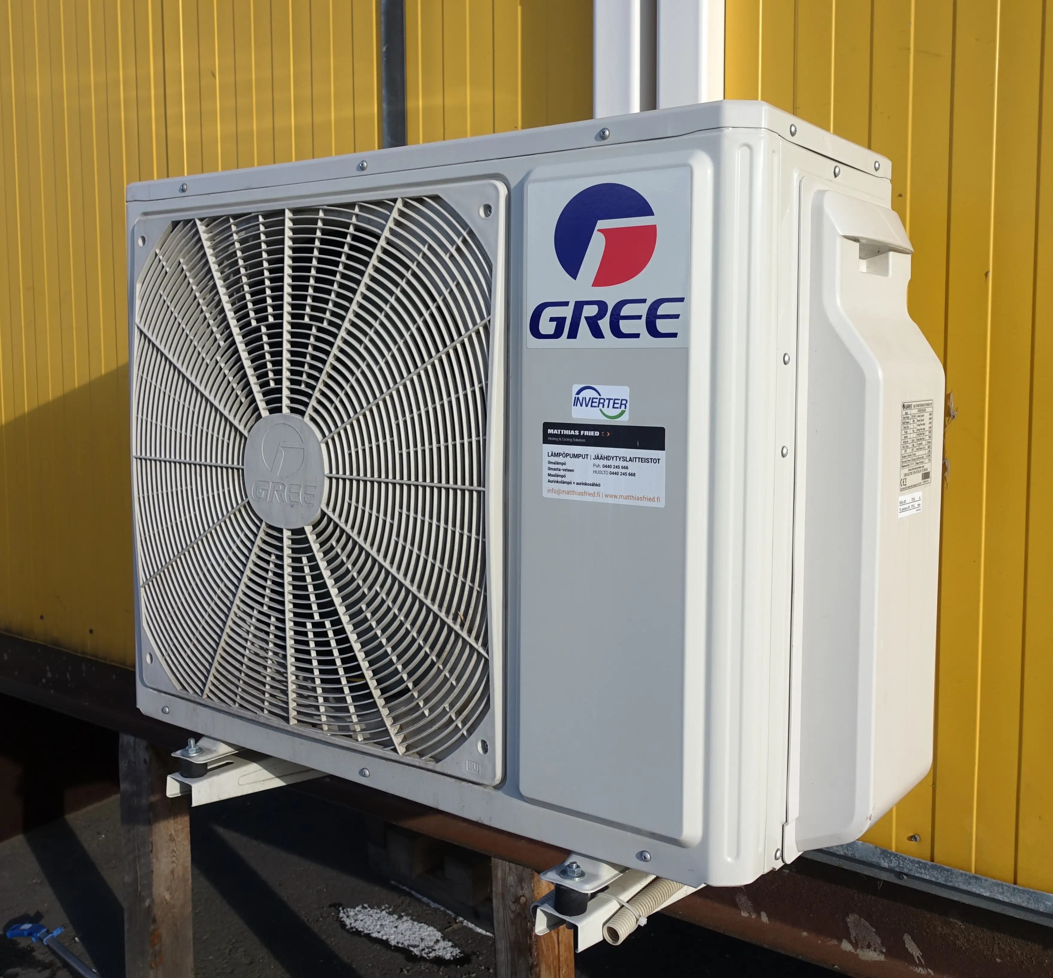Cold climate heat pump running outdoors in snowy winter conditions